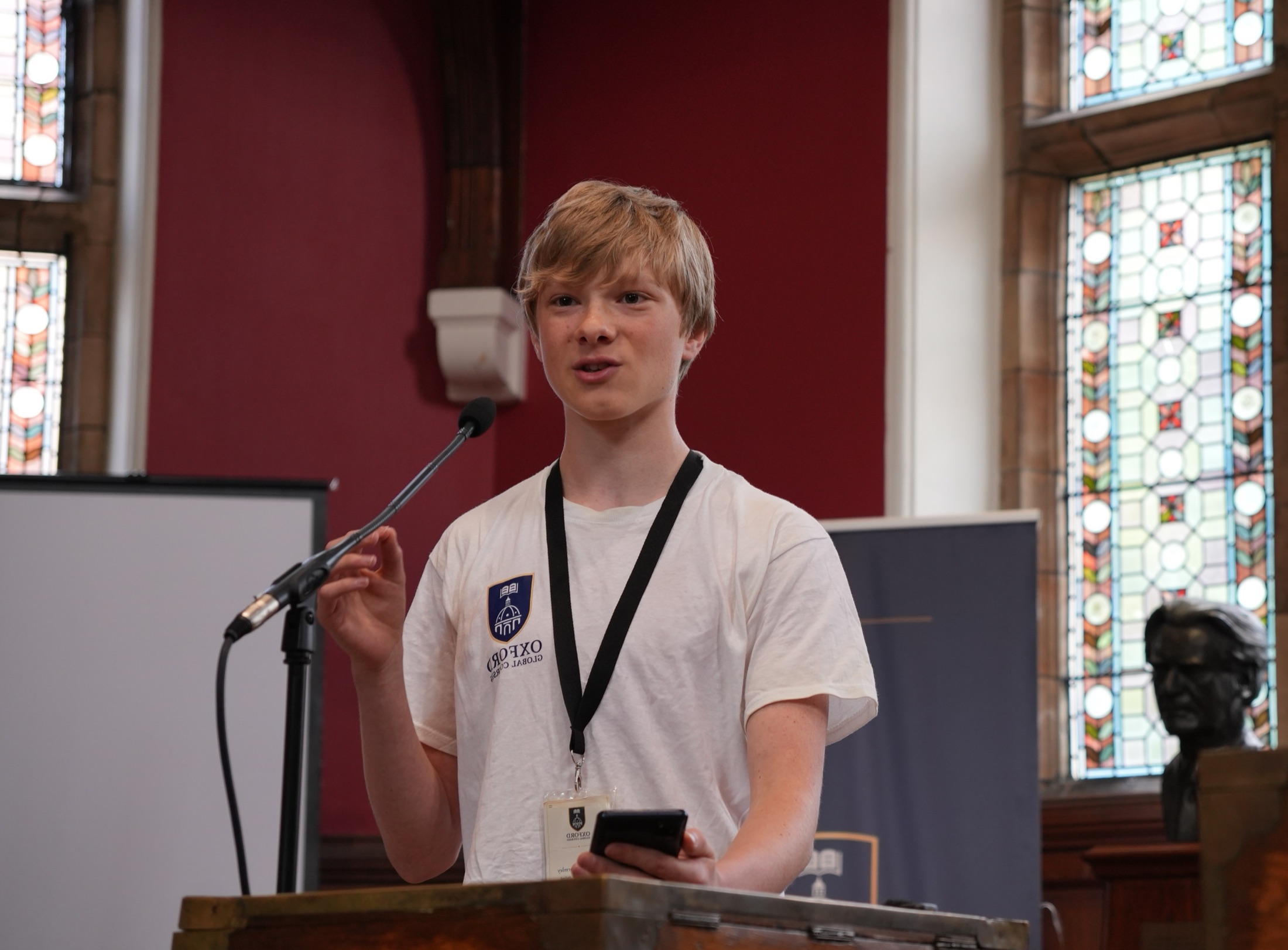 An Oxford Summer Academy student speaking from a lectern