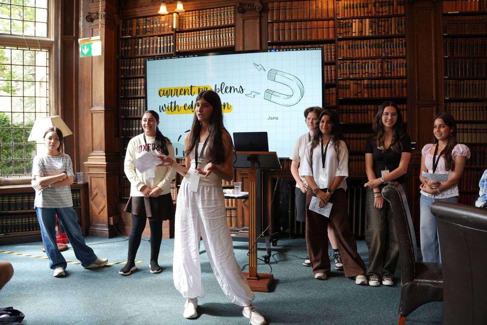 A student presenting an academic project to peers in Oxford